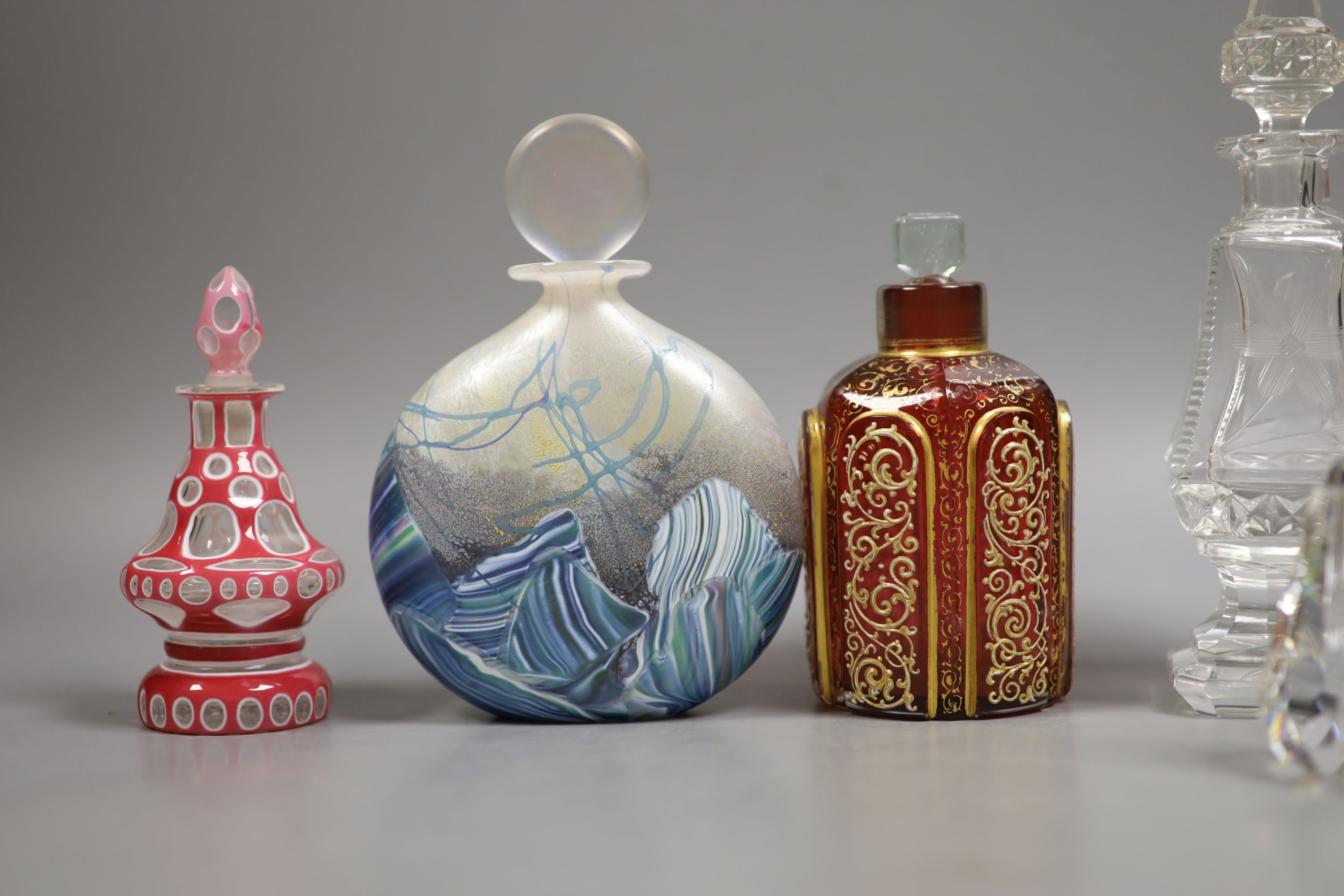A collection of various glass scent bottles including a Lalique flower scent bottle and Bohemian examples, tallest 20.5cm